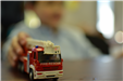 Boy holding model fire truck