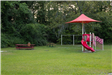 red playground structure and red picnic tables