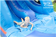 boy at the bottom of blue water slide