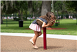 girl leaning on playground equipment