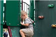 boy climbing on rock wall