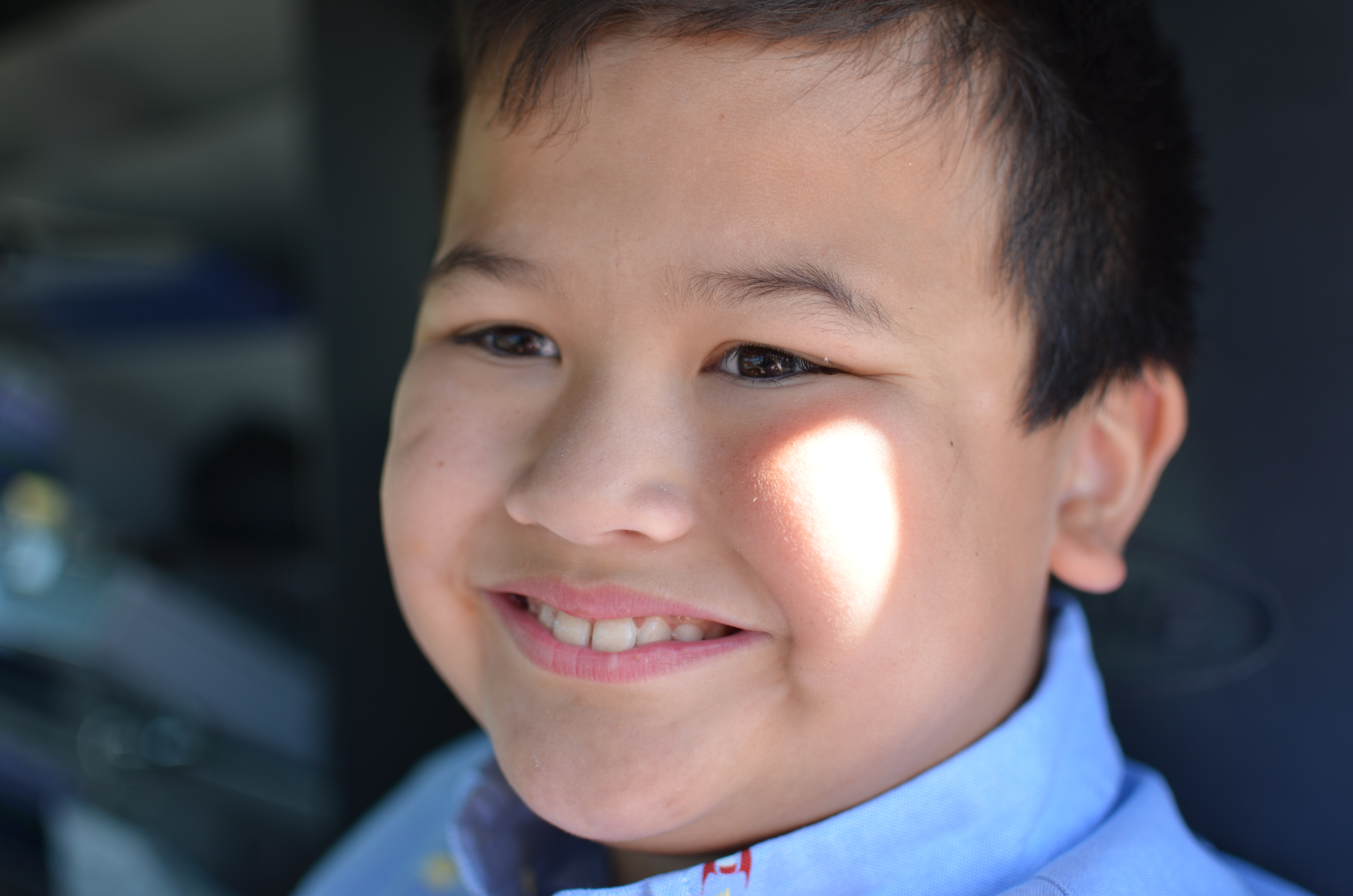 smiling boy sitting in fire truck