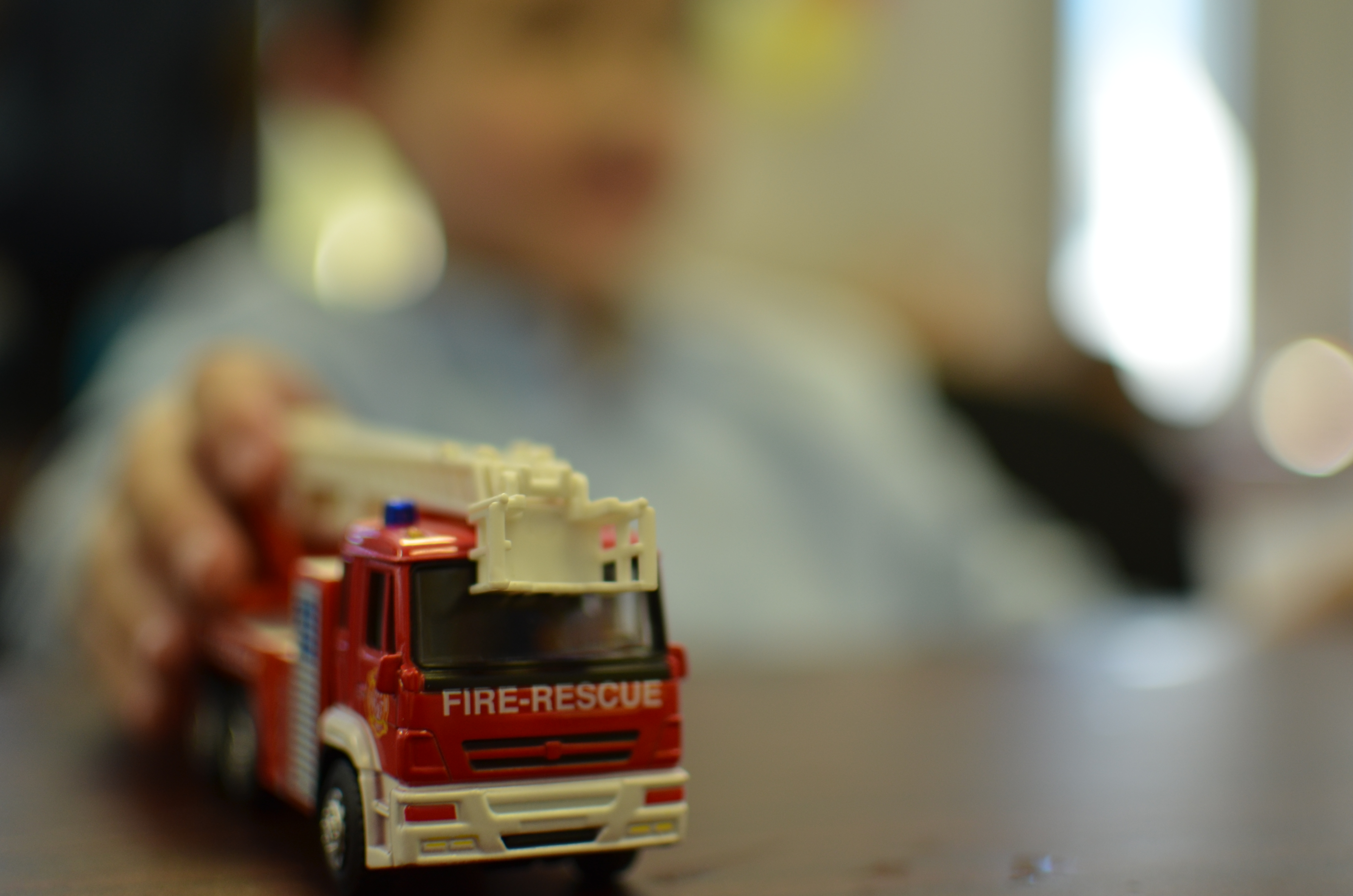 Boy holding model fire truck