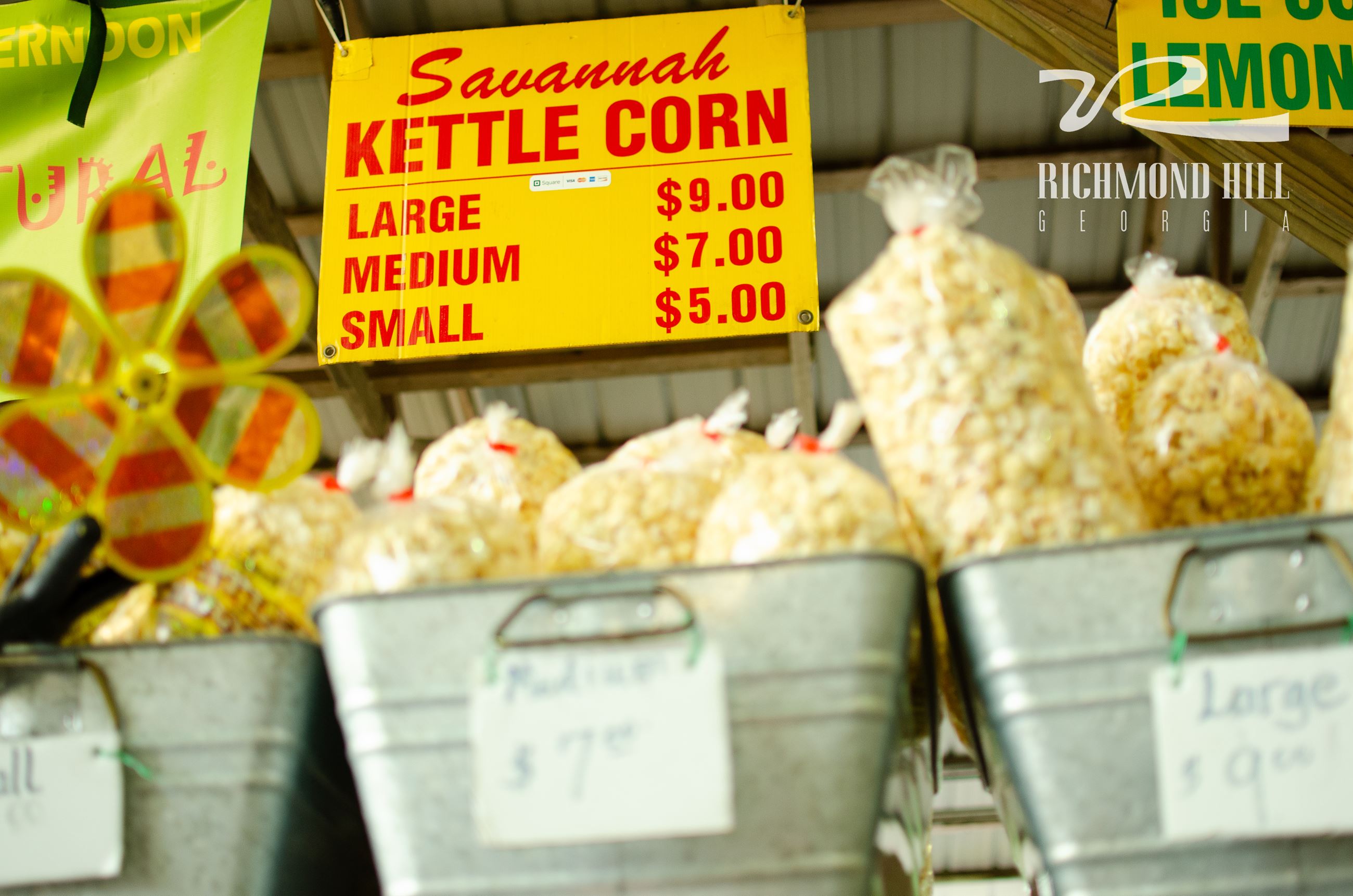 three silver bins filled with bags of popcorn 