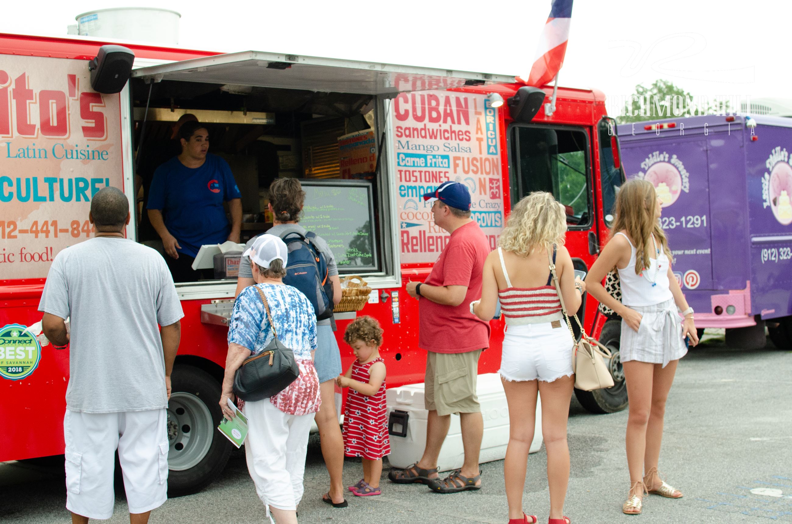 family standing in line at a food truck