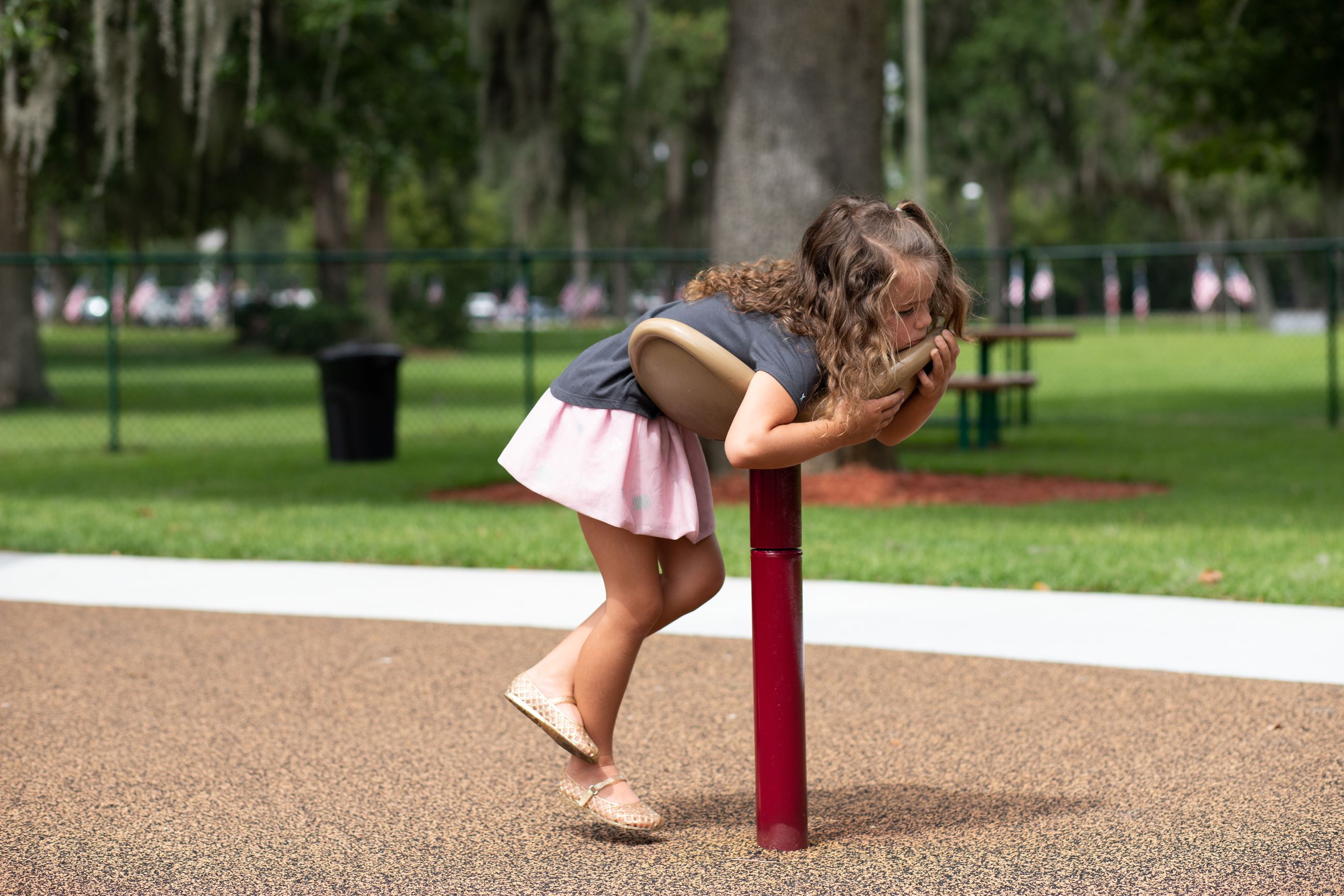 girl leaning on playground equipment