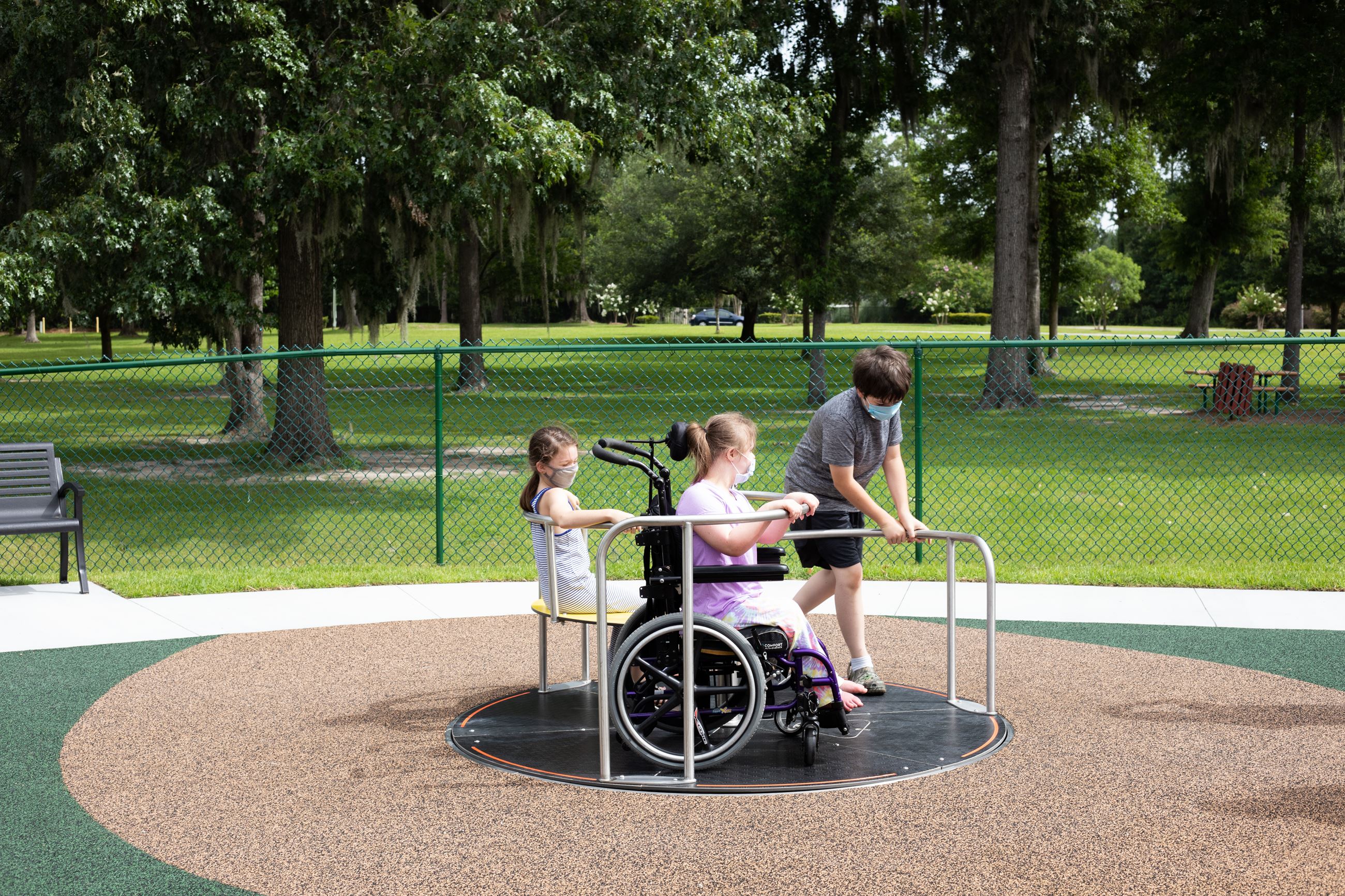 kids playing on merry-go-round
